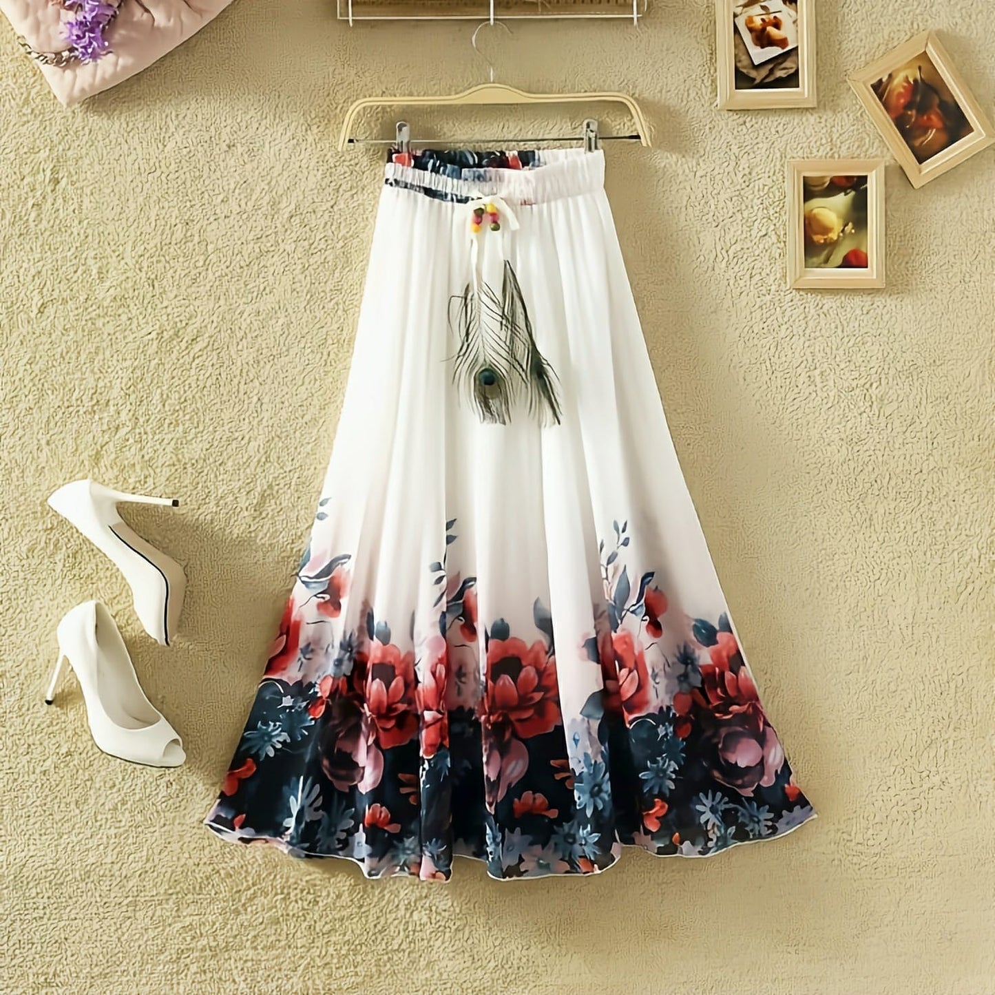 A floral print silk skirt in white, blue, and red, with a button and fancy dori work, displayed on a hanger.