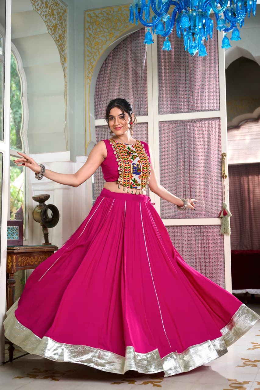 Woman in vibrant pink lehenga and traditional Gamthi work blouse – perfect Navratri outfit

