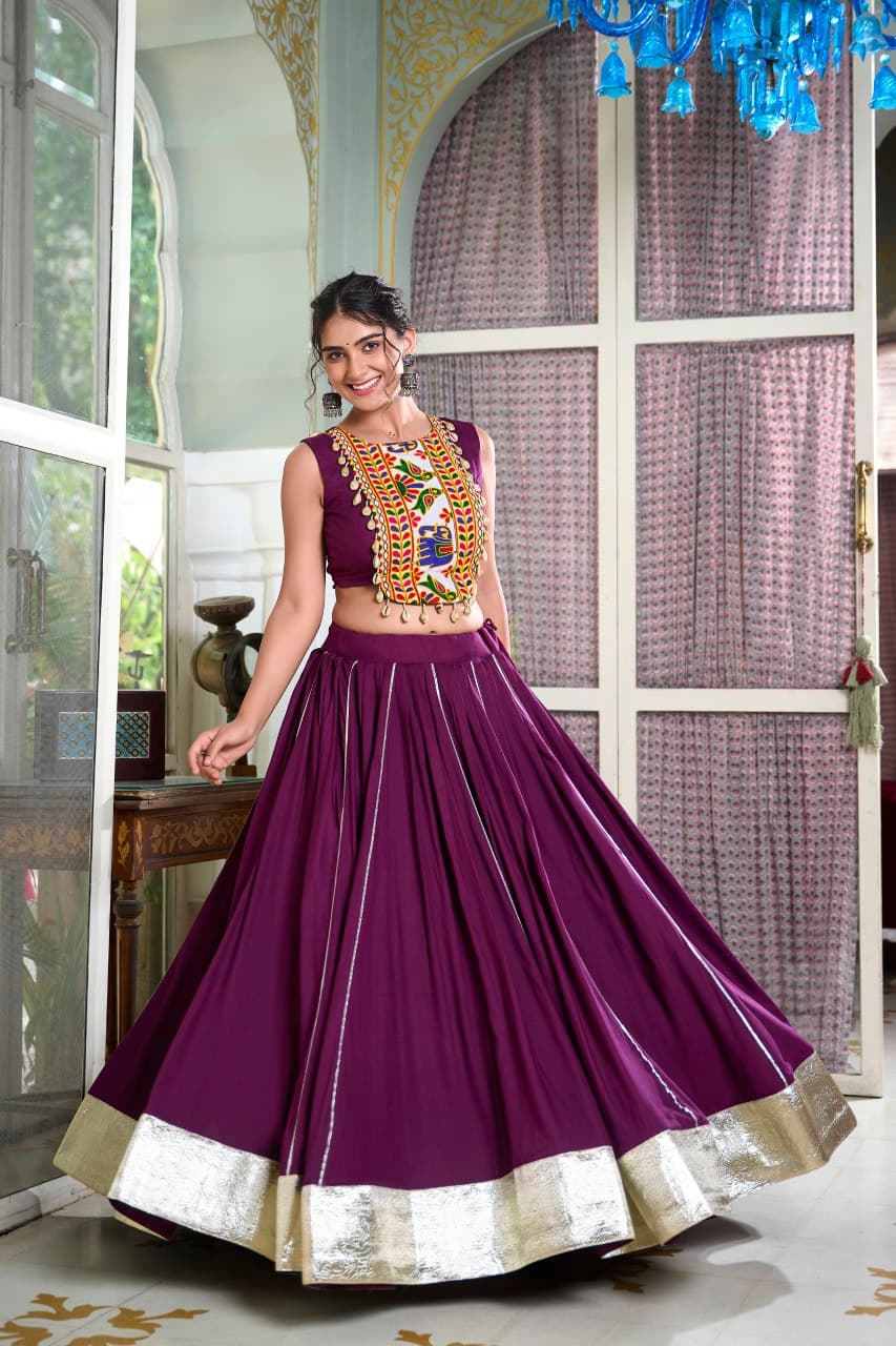 Woman wearing wine-colored rayon lehenga with Gamthi embroidered blouse – perfect for Navratri 2025